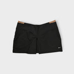 Nike skirt in black featuring a contrast tan waistband trim and embroidered white Swoosh