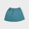 Blue Nike tennis skirt featuring a colourful Nike Court logo patch near the hem.