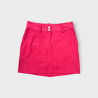 Pink Nike Golf skirt with white double button closure and belt loops