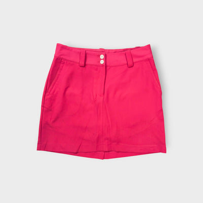 Pink Nike Golf skirt with white double button closure and belt loops