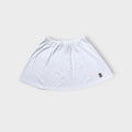 Nike mini tennis skirt in white with a colorful embroidered court logo patch near hem