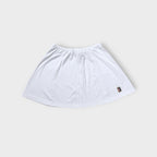 Nike mini tennis skirt in white with a colorful embroidered court logo patch near hem