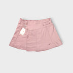 Pink Nike tennis skirt with decorative side buttons and an embroidered swoosh logo