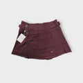 Nike women's tennis skirt in dark red with side button closures and waist buckles.