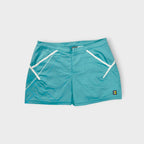 Nike turquoise tennis skirt featuring white trim and a small court patch at the hem.