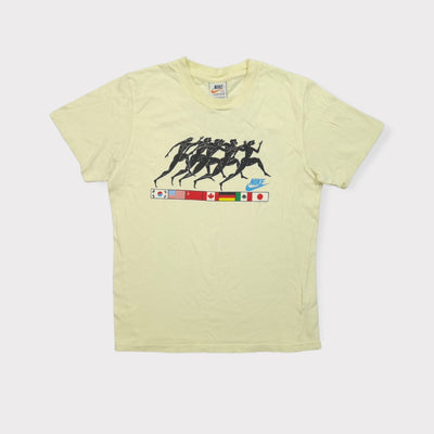 Nike T-Shirt in beige featuring a graphic of ancient runners above national flags