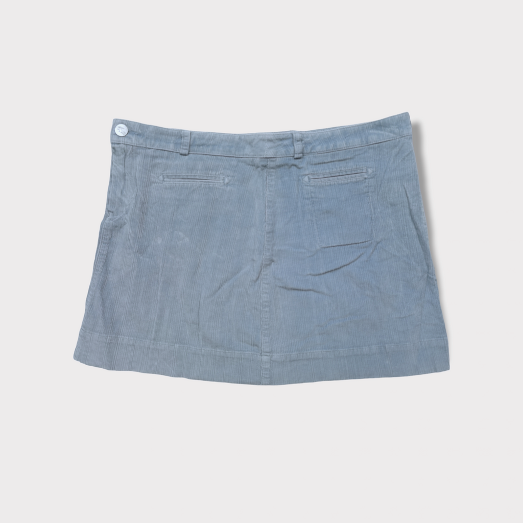 Lacoste corduroy skirt in blue featuring a brown leather waistband logo patch and button.