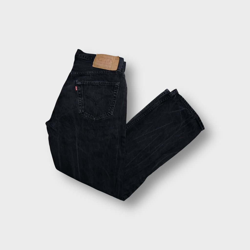 Levi's black jeans with leather back patch and red tab on pocket
