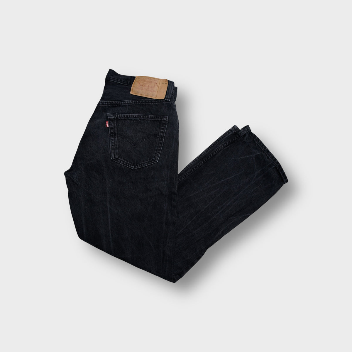 Levi's black jeans with leather back patch and red tab on pocket