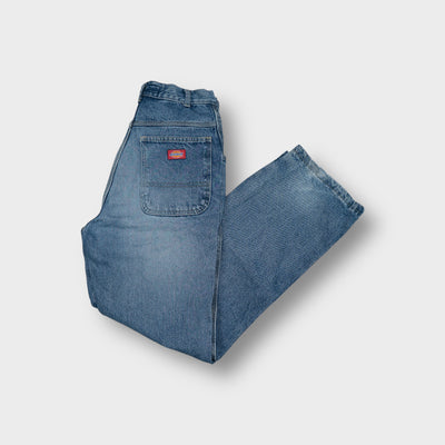 Dickies denim jeans in blue featuring a red woven logo patch on the back pocket