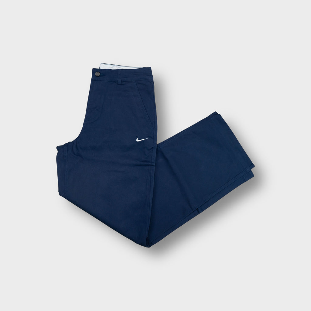 Nike blue jeans with an embroidered white swoosh on the front thigh