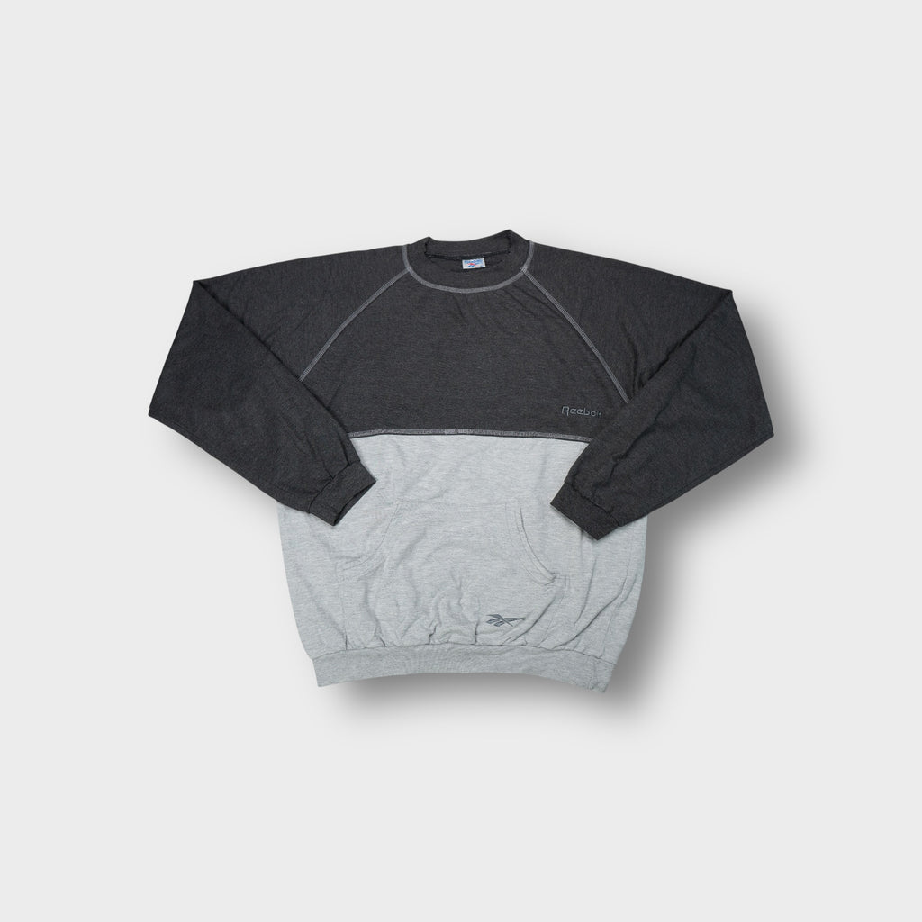 Grey Reebok sweater with contrasting paneling and front kangaroo pocket