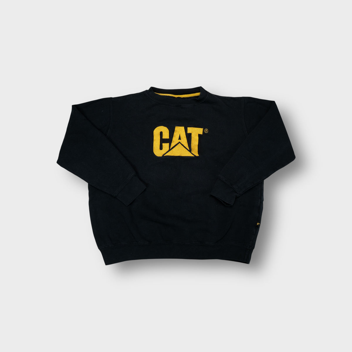 CAT sweatshirt in black featuring a yellow embroidered chest logo