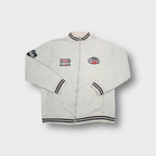 Beige full-zip sweater jacket with striped ribbed collar and racing patches.