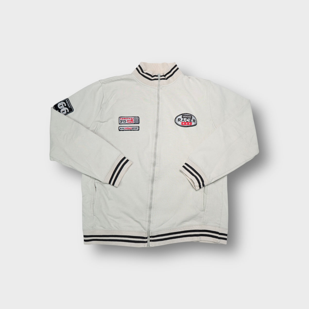Beige full-zip sweater jacket with striped ribbed collar and racing patches.