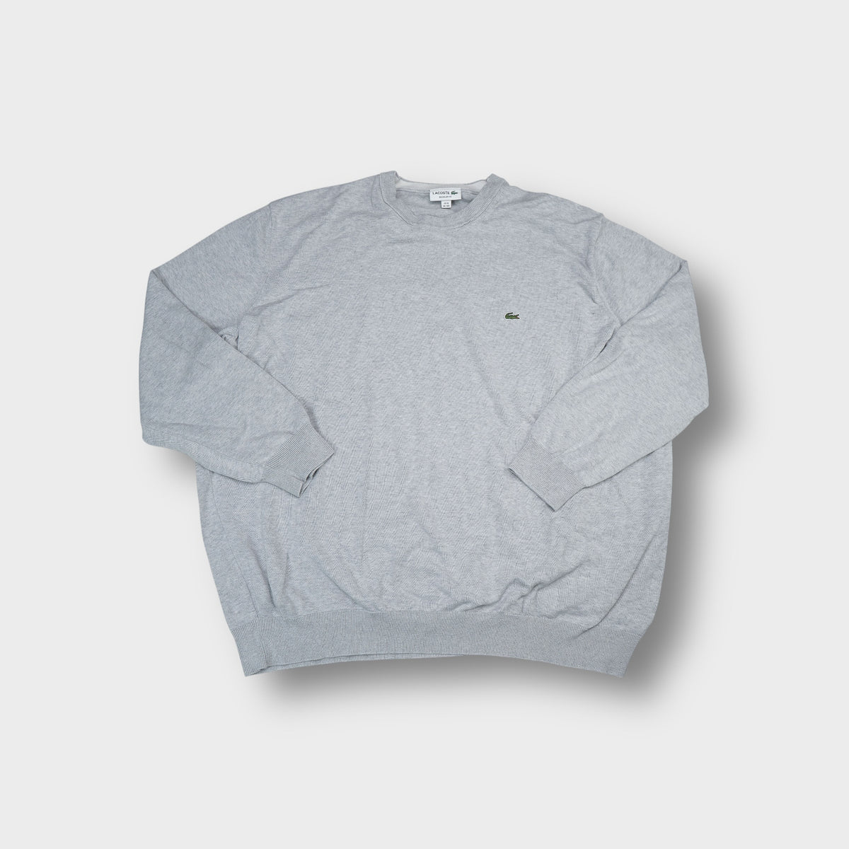 Grey Lacoste knit sweater featuring a small embroidered crocodile logo on the chest