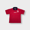 Umbro football jersey in red with a navy collar and crest on the chest