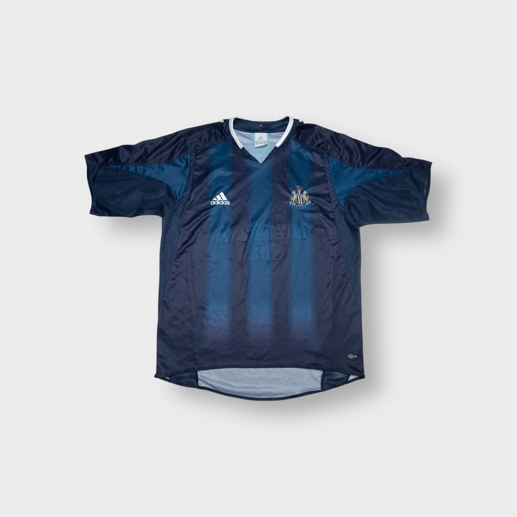 Adidas blue Newcastle United football shirt featuring an embroidered club crest and V-neck collar