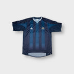 Adidas blue Newcastle United football shirt featuring an embroidered club crest and V-neck collar