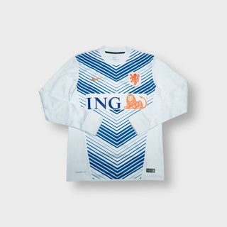 White Nike Netherlands sweater with blue chevron graphic and orange lion crest.