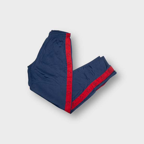 Blue Carabinieri trackpants with red side stripes featuring printed grenade symbols.