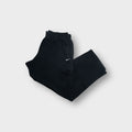 Black Nike cargo sweatpants with elastic waistband and small white embroidered swoosh logo