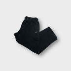 Black Nike cargo sweatpants with elastic waistband and small white embroidered swoosh logo