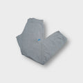 Nike sweatpants in grey with small blue embroidered logo on hip