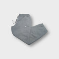 Nike grey sweatpants with a white embroidered Swoosh logo near the side pocket