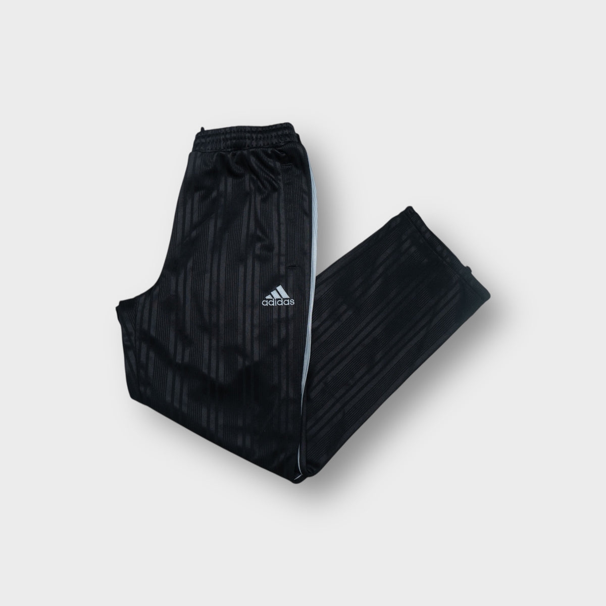 Black Adidas Japan football track pants featuring the embroidered JFA emblem and logo.