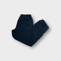 Adidas navy blue trackpants with an embroidered logo near the front pocket
