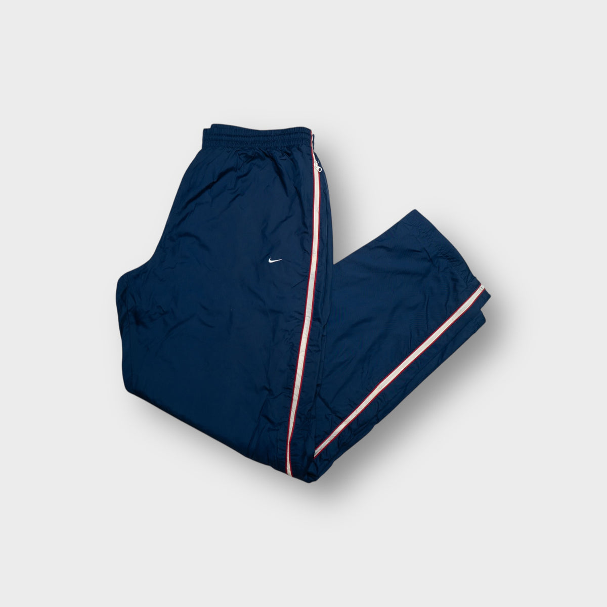 Nike trackpants in blue with red and white striped full side zips