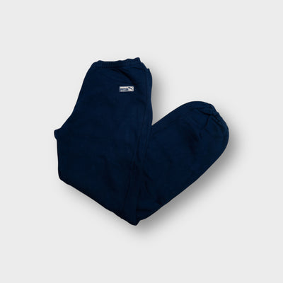 Puma sweatpants in navy blue featuring a small woven logo patch at the hip