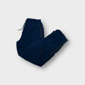 Nike navy blue trackpants featuring zipped side pockets and an elastic drawstring waist
