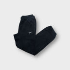 Nike sweatpants in black featuring a small white embroidered swoosh logo