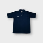 Umbro polo shirt in navy blue with an embroidered white chest logo.