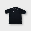 Umbro polo shirt in black featuring an embroidered chest logo patch and grey tipped collar