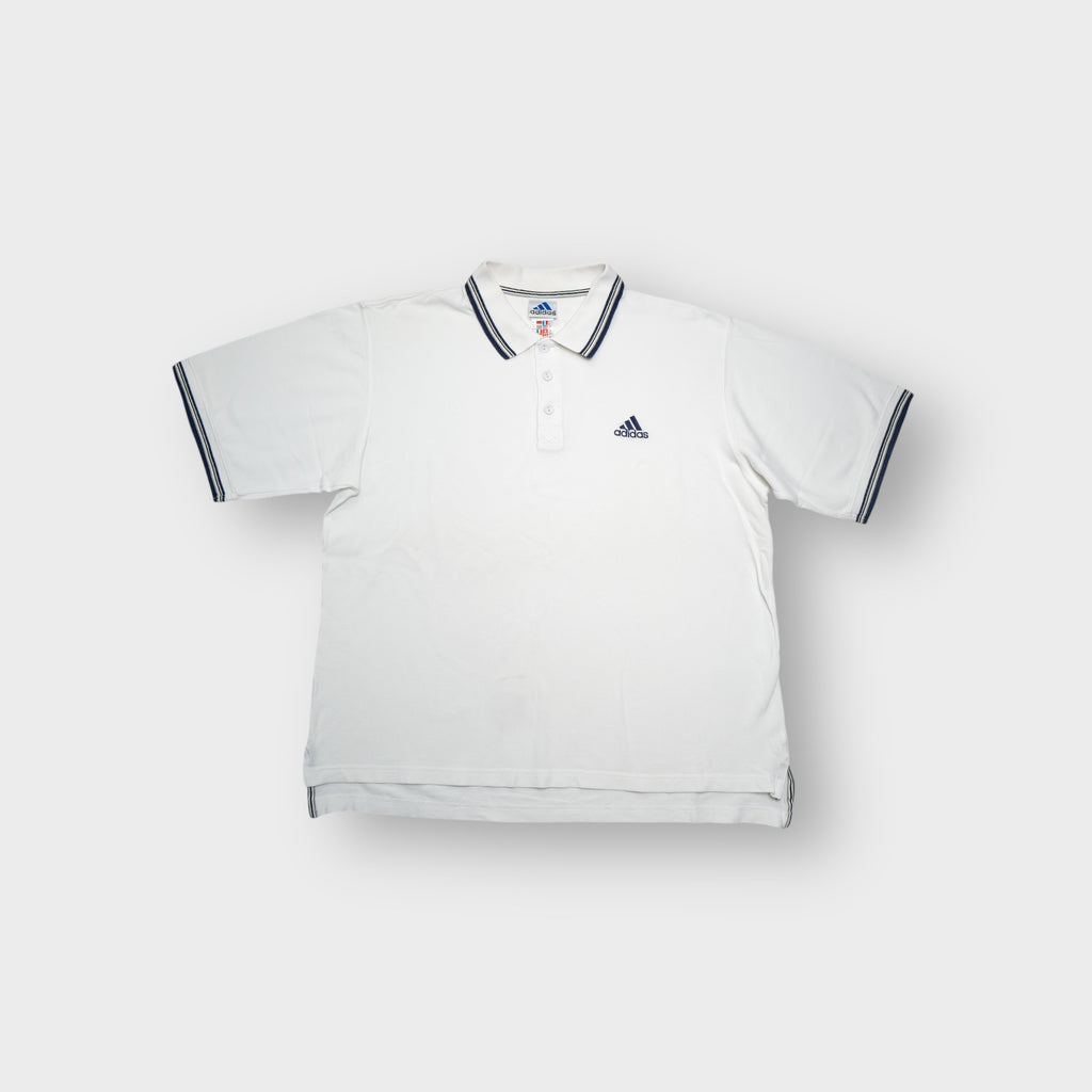 Adidas white polo shirt featuring striped collar trim and embroidered chest logo