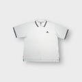 Adidas white polo shirt featuring striped collar trim and embroidered chest logo