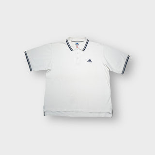 Adidas white polo shirt featuring striped collar trim and embroidered chest logo