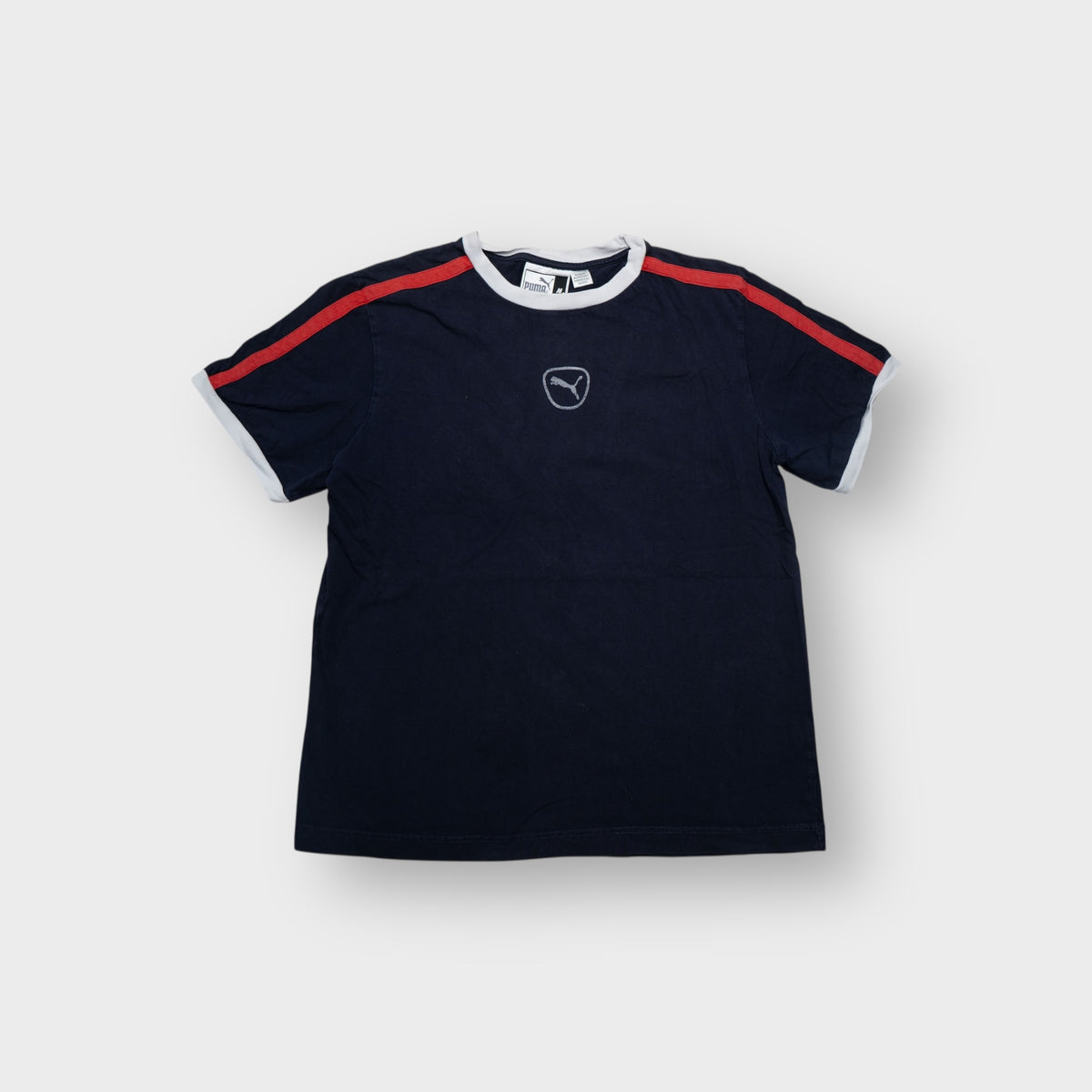 Puma navy blue T-Shirt featuring a central cat logo chest print and red shoulder stripes