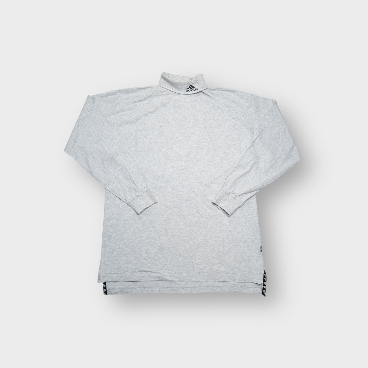 Grey Adidas turtleneck sweater featuring an embroidered equipment logo on the high collar.