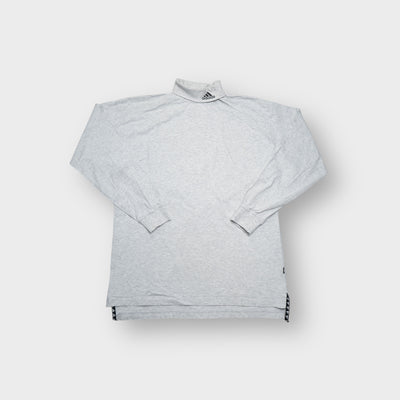 Grey Adidas turtleneck sweater featuring an embroidered equipment logo on the high collar.