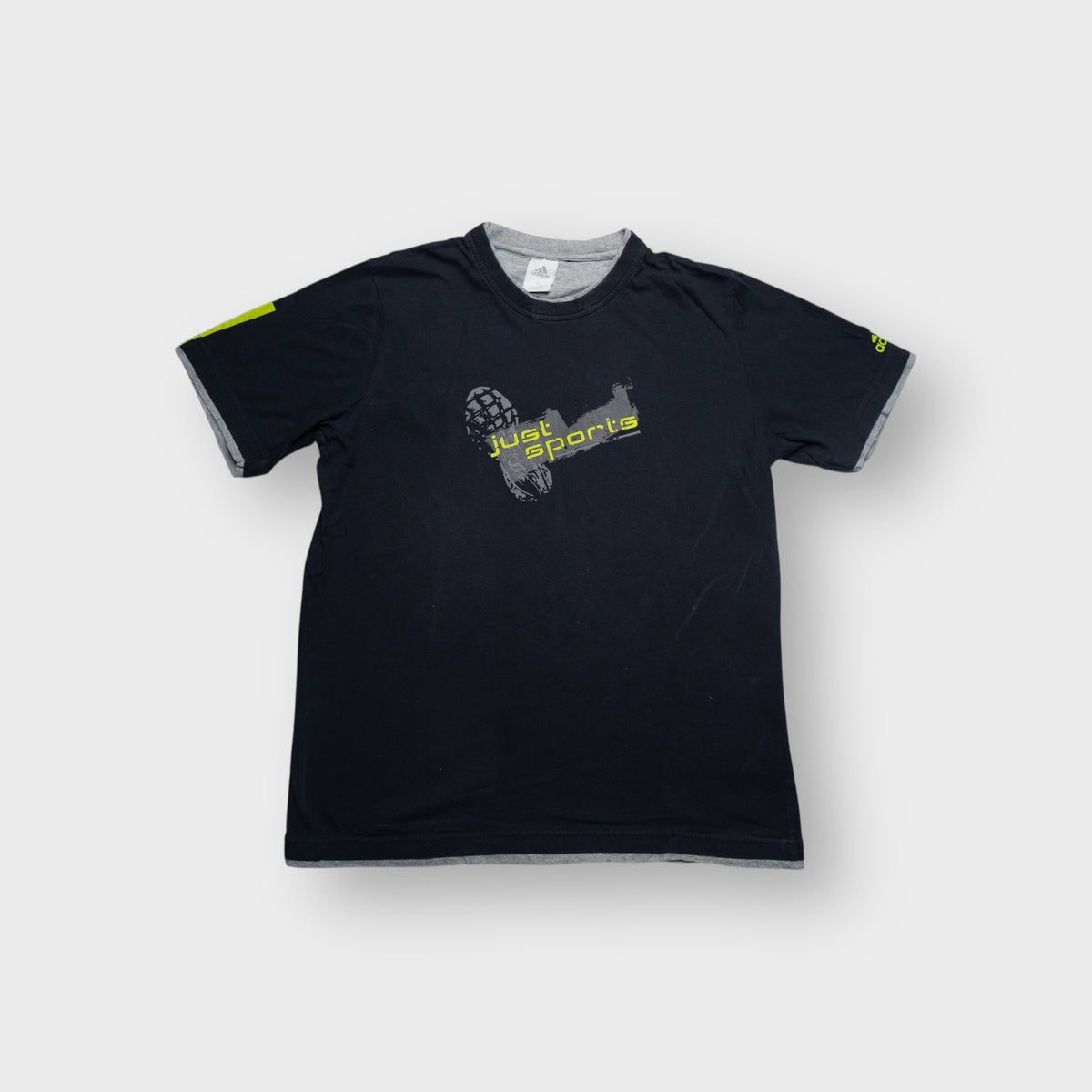 Adidas navy blue T-Shirt featuring a yellow Just Sports graphic print on the front