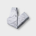 Adidas trackpants in silver featuring black side stripes and embroidered logo