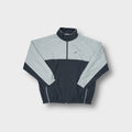 Reebok track jacket in grey and dark navy featuring a small chest logo.
