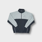 Reebok track jacket in grey and dark navy featuring a small chest logo.