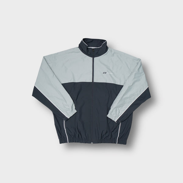 Reebok track jacket in grey and dark navy featuring a small chest logo.