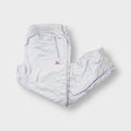 Puma trackpants in light grey with a purple embroidered logo and zipped pockets