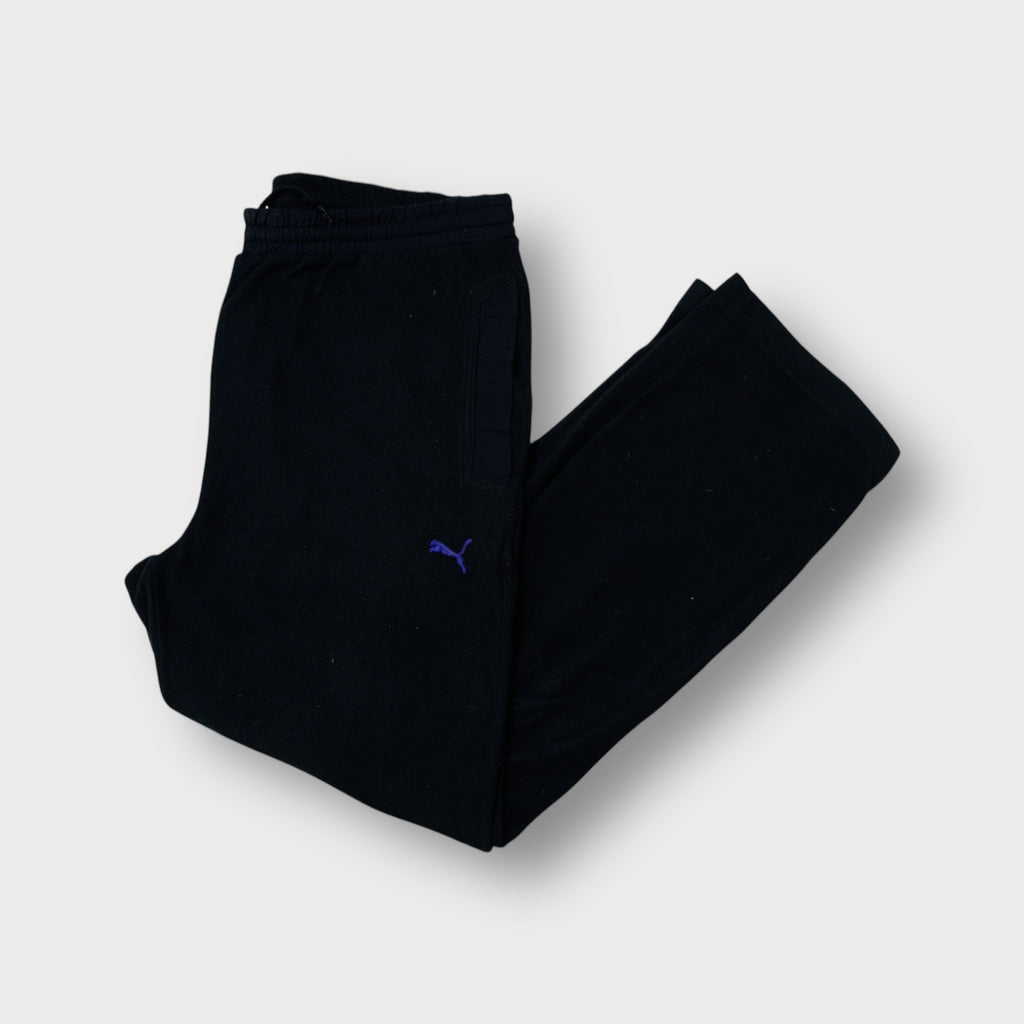 Puma fleece pants in black featuring a small purple embroidered logo on the thigh